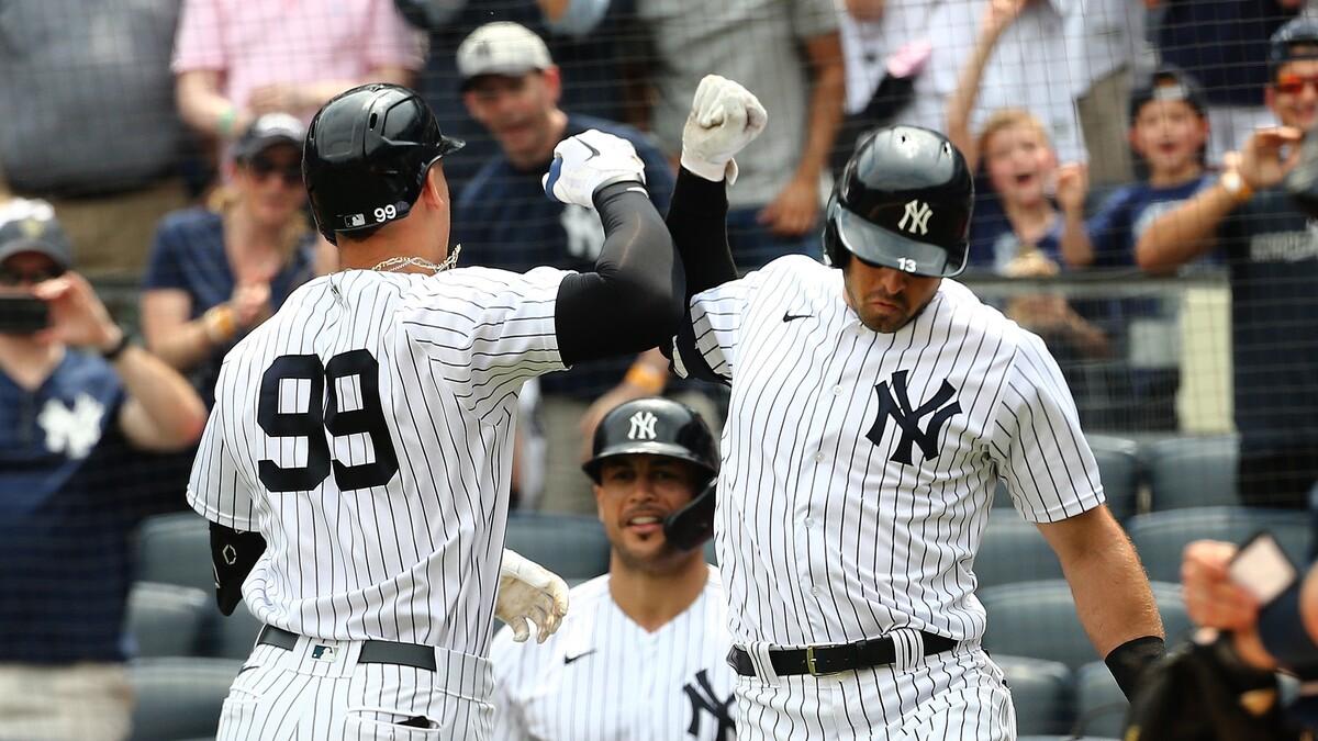 New York Yankees designated hitter Aaron Judge (99) is cogratulated by left fielder Joey Gallo (13) after hitting a solo home against the Seattle Mariners during the first inning at Yankee Stadium.