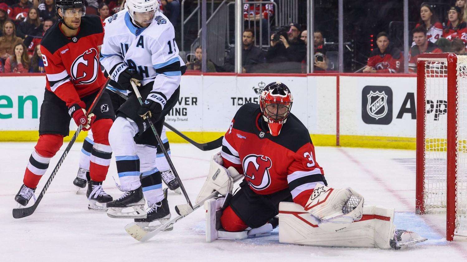 Oct 14, 2024; Newark, New Jersey, USA; New Jersey Devils goaltender Jake Allen (34) makes a save against the Utah Hockey Club during the third period at Prudential Center.