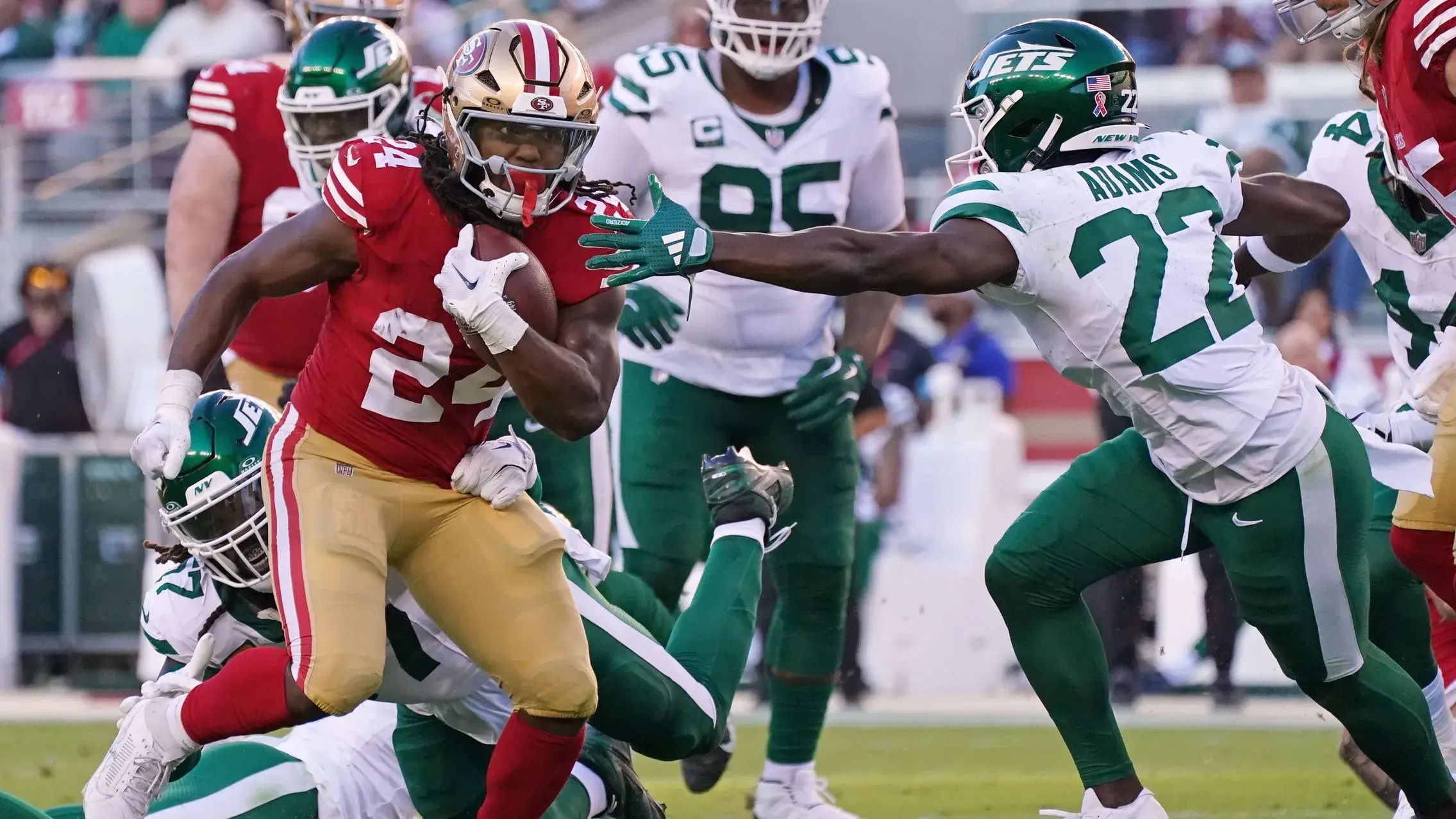 San Francisco 49ers running back Jordan Mason (24) runs against New York Jets safety Tony Adams (22) during the second quarter at Levi's Stadium. / David Gonzales-Imagn Images