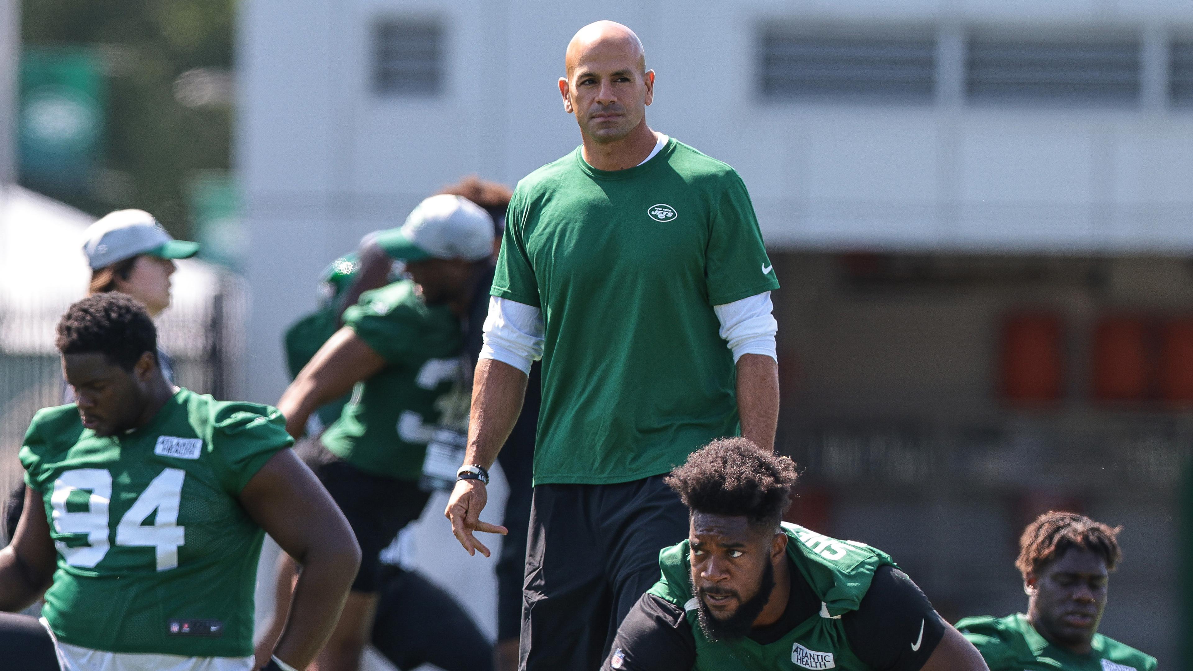 New York Jets head coach Robert Saleh walks between defensive tackle Foley Fatukasi (94) and defensive end Nathan Shepherd (97) during training camp at Atlantic Health Jets Training Center.