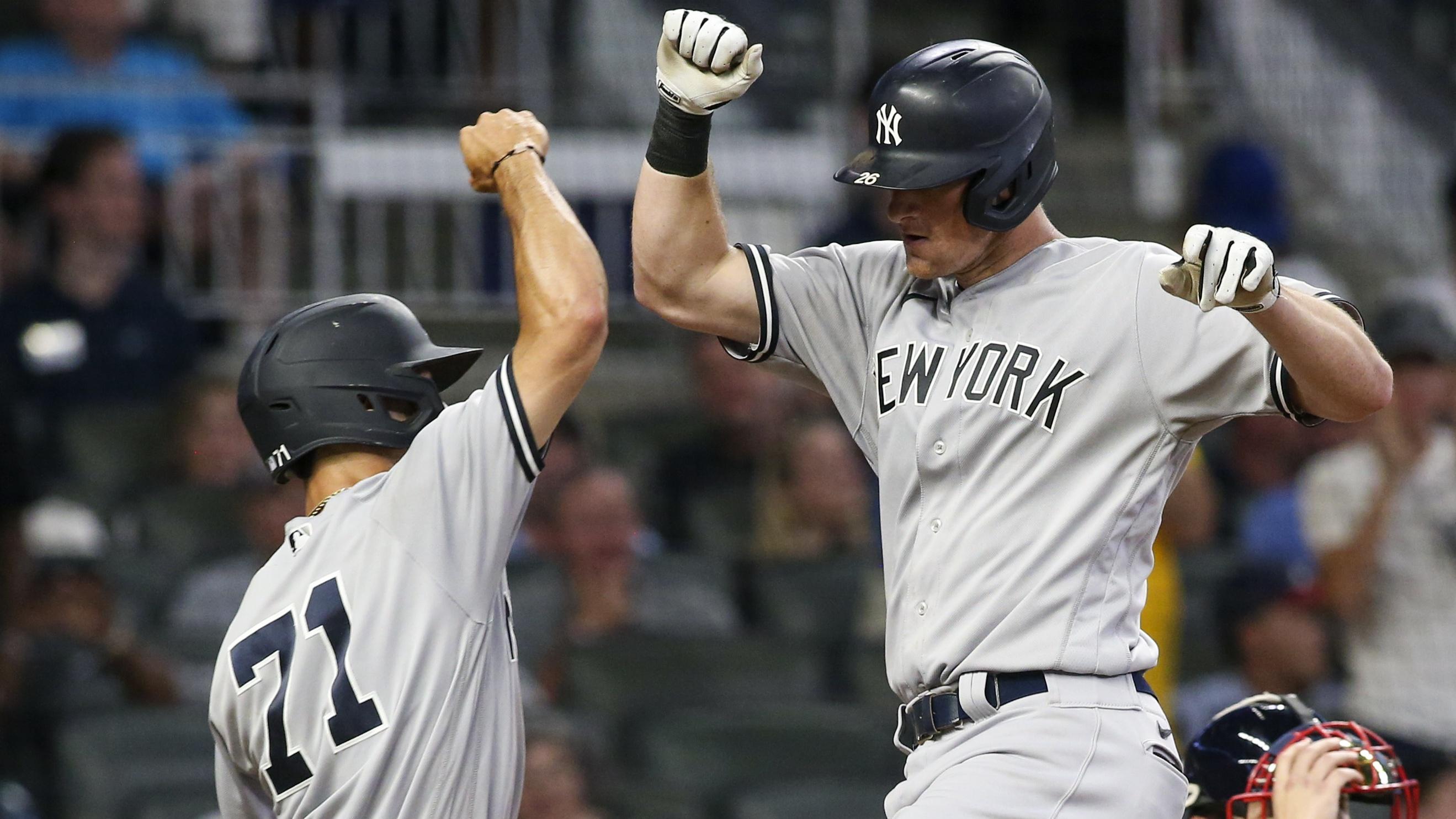 Aug 24, 2021; Atlanta, Georgia, USA; New York Yankees second baseman DJ LeMahieu (26) celebrates with shortstop Andrew Velazquez (71) after hitting a two-run home run against the Atlanta Braves in the fifth inning at Truist Park.