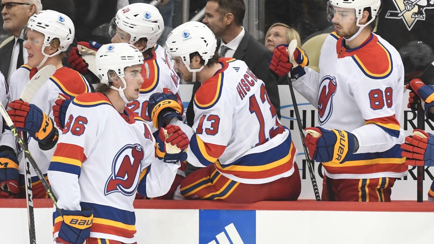 Dec 30, 2022; Pittsburgh, Pennsylvania, USA; New Jersey Devils center Jack Hughes (86) is greeted by his teammates after scoring against the Pittsburgh Penguins during the third period at PPG Paints Arena.