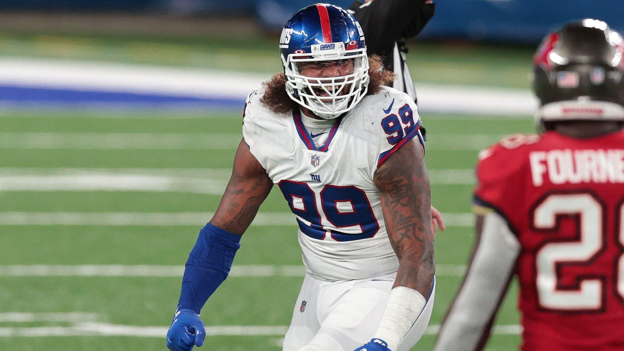 Nov 2, 2020; East Rutherford, New Jersey, USA; New York Giants defensive end Leonard Williams (99) celebrates his sack of Tampa Bay Buccaneers quarterback Tom Brady (12) with linebacker Kyler Fackrell (51) in front of running back Leonard Fournette (28) during the first half at MetLife Stadium. Mandatory Credit: Vincent Carchietta-USA TODAY Sports / © Vincent Carchietta-USA TODAY Sports