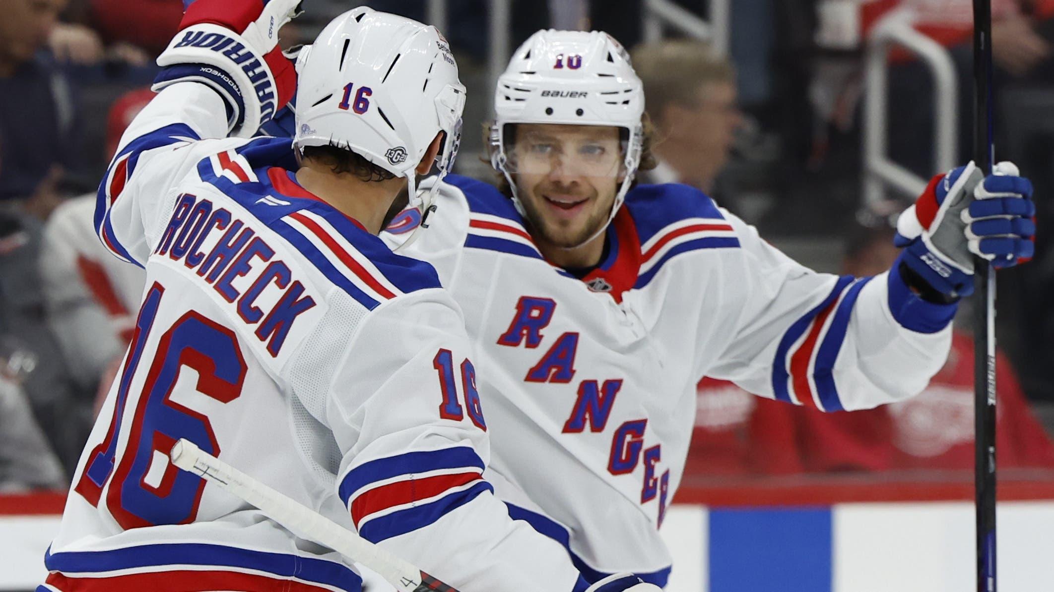 New York Rangers left wing Artemi Panarin (10) receives congratulations from teammates after scoring in the first period against the Detroit Red Wings at Little Caesars Arena