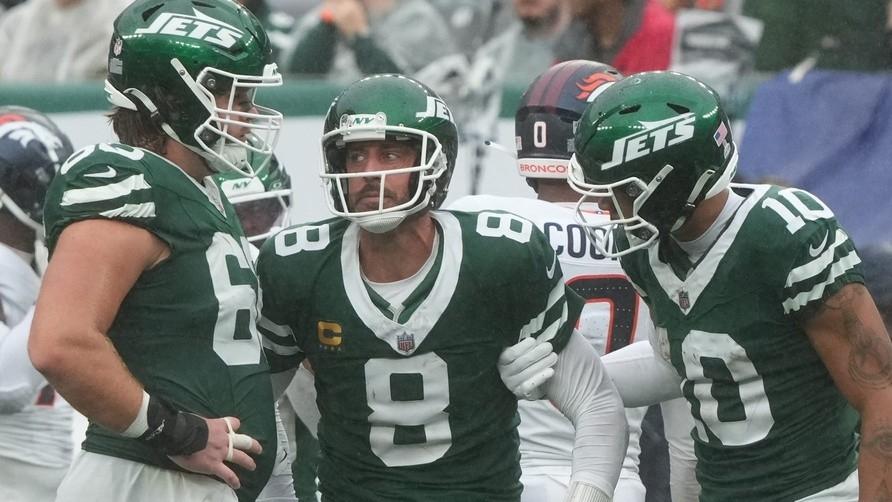 Jets quarterback Aaron Rodgers being helped up by teammates after he was sacked in the fourth quarter as the Denver Broncos beat the New York Jets 10-9 at MetLife Stadium.